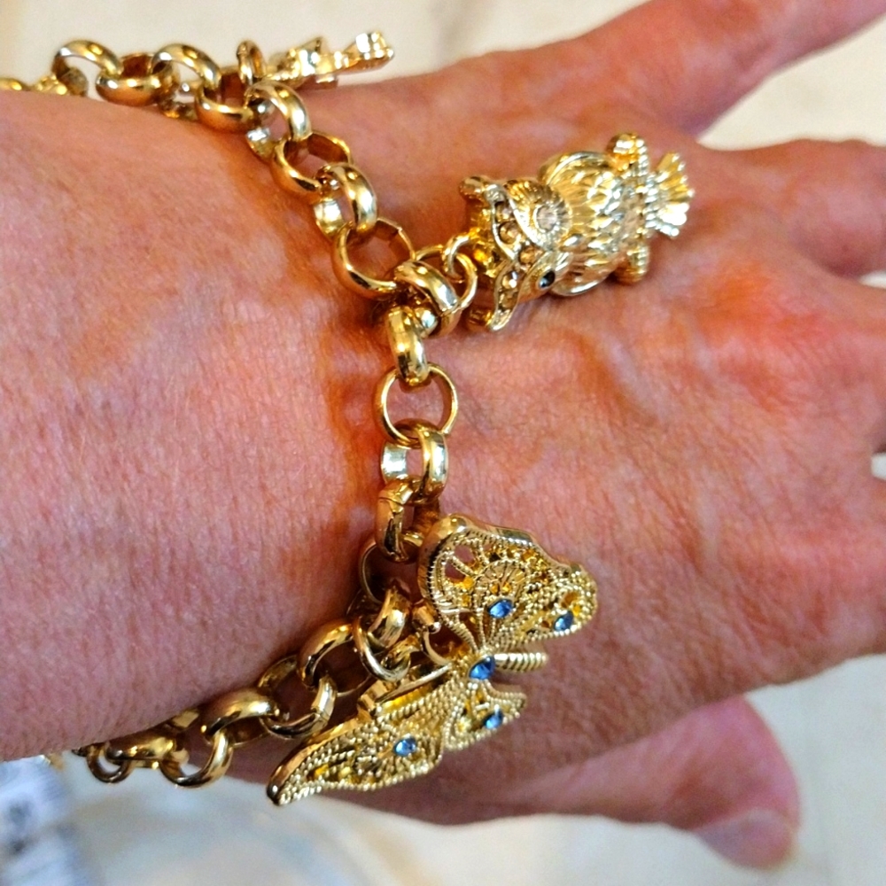 M gold charms bracelet with 5 beautiful charms.